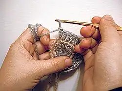 Most crochet uses one hook and works upon one stitch at a time.  Crochet may be worked in circular rounds without any specialized tools, as shown here.
