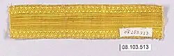 A length of plain, bright gold braid with a zigzag border