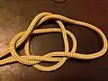 8-3-The resulting loop is folded under and the slip side of the overhand knot pulled through it