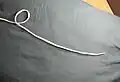 2. Start an overhand knot, leaving enough rope for the loop and the rest of the knot.